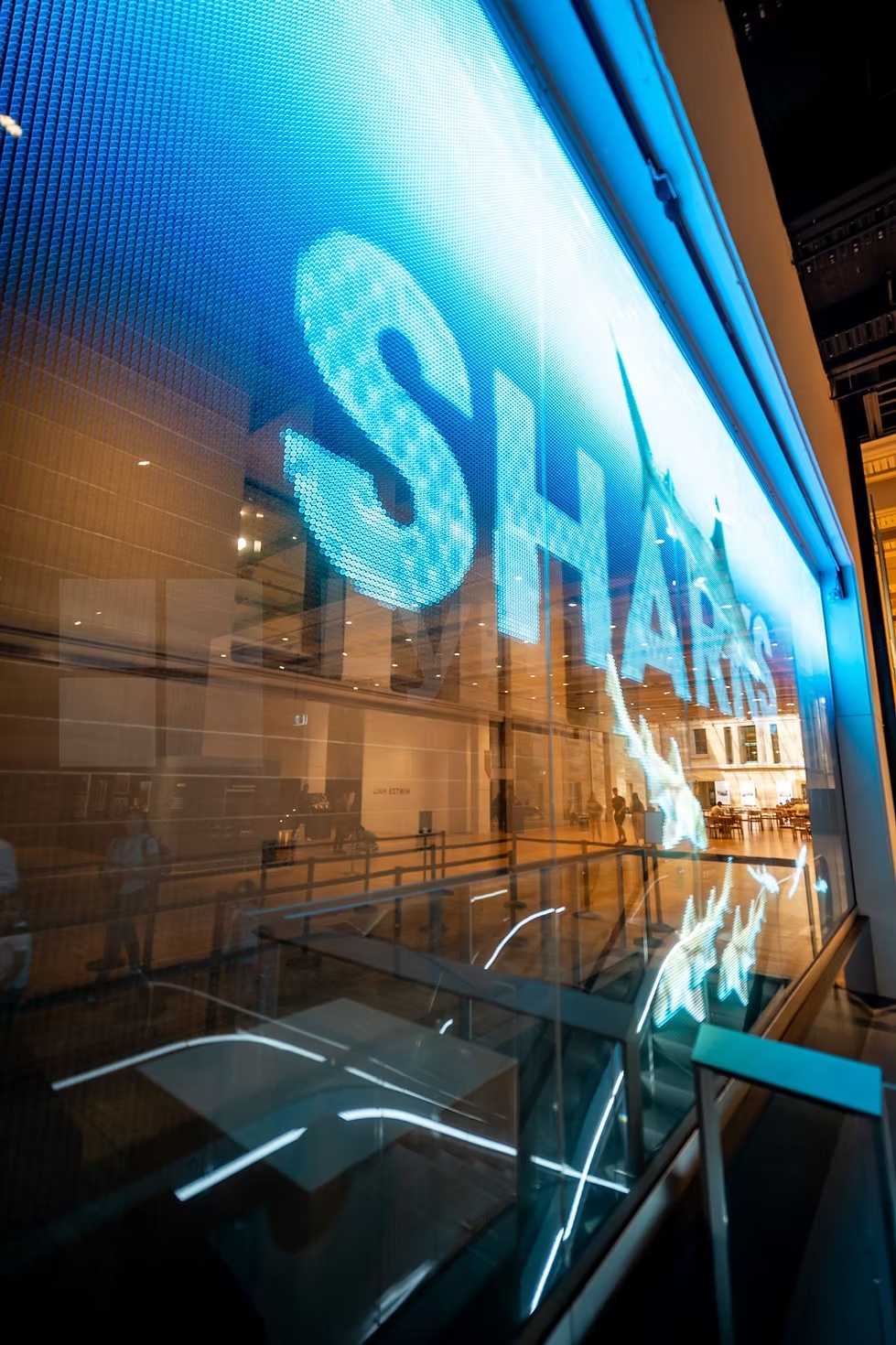 Close-up of transparent LED screen at the Australian Museum with bright blue visuals for the Sharks display.